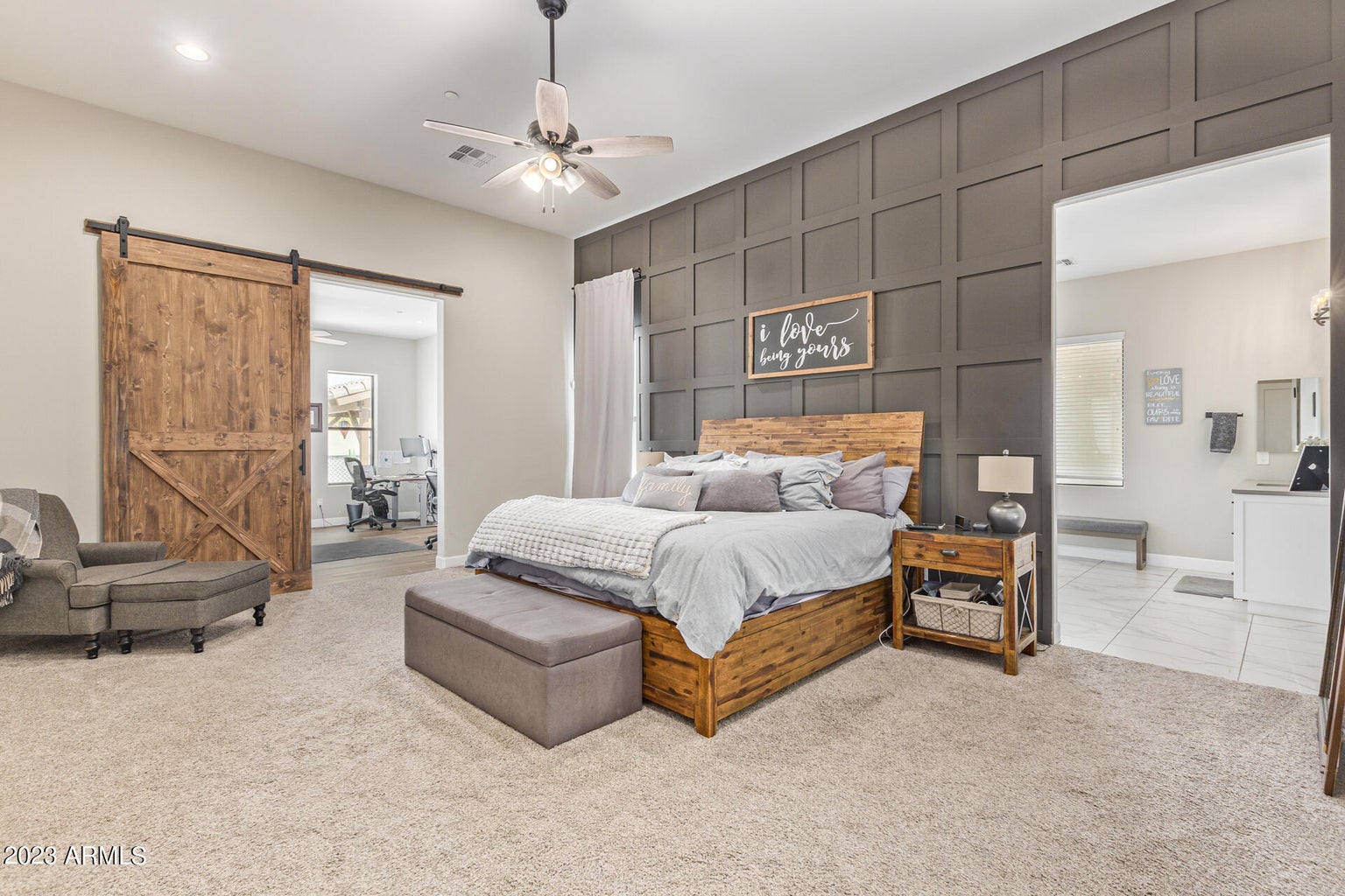 A luxury real estate bedroom with a bed, dresser and closet in Greater Scottsdale.