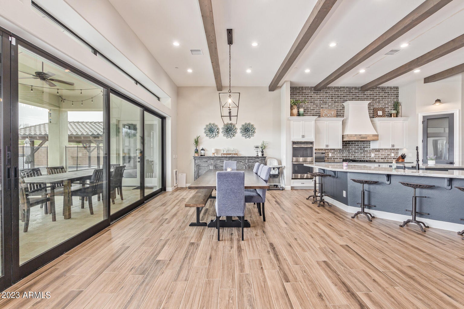 A luxurious kitchen with marble counter tops and bar stools in Greater Scottsdale's Denali Development Construction.