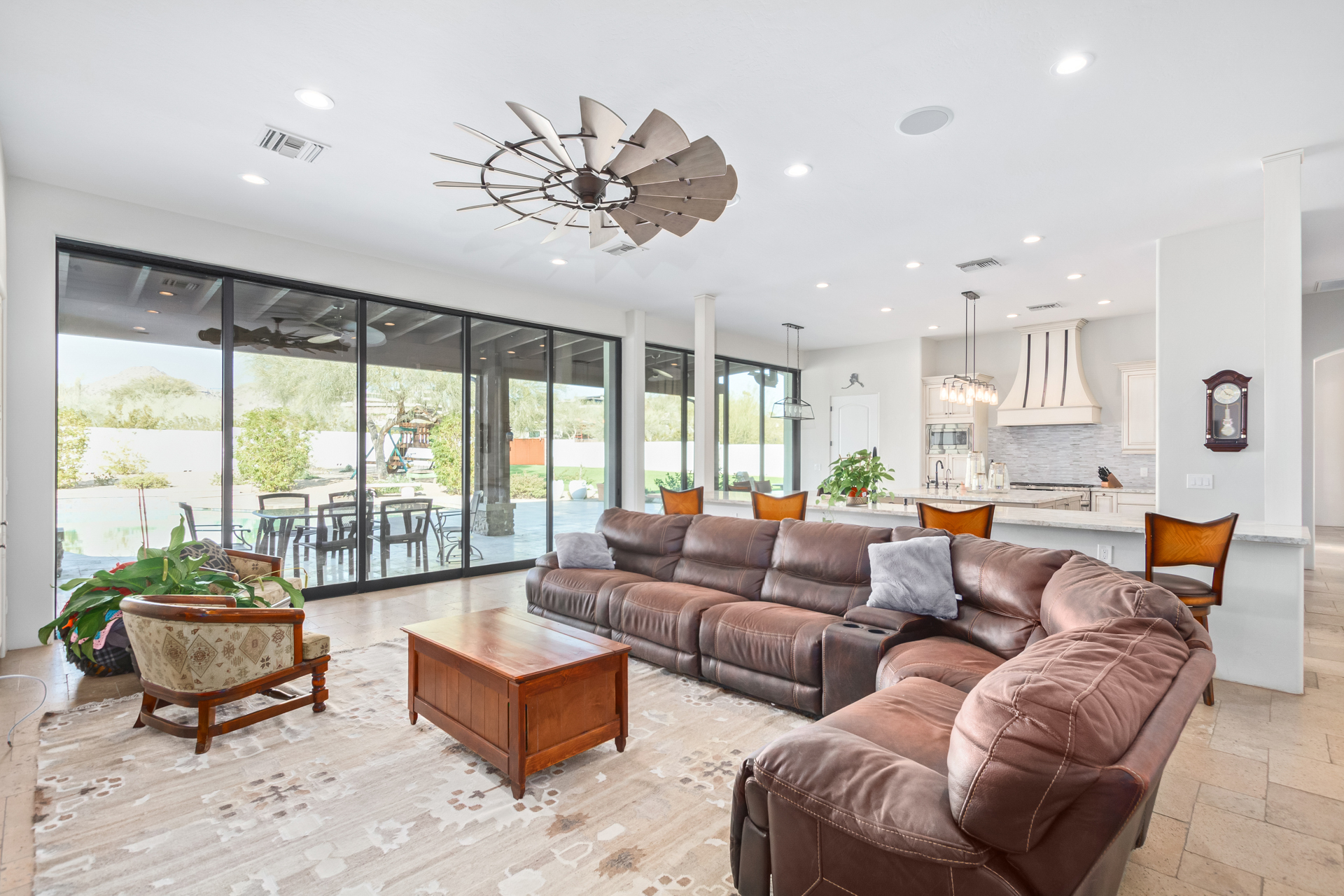 A luxury living room in Greater Scottsdale with ceiling fan and sliding glass doors.
