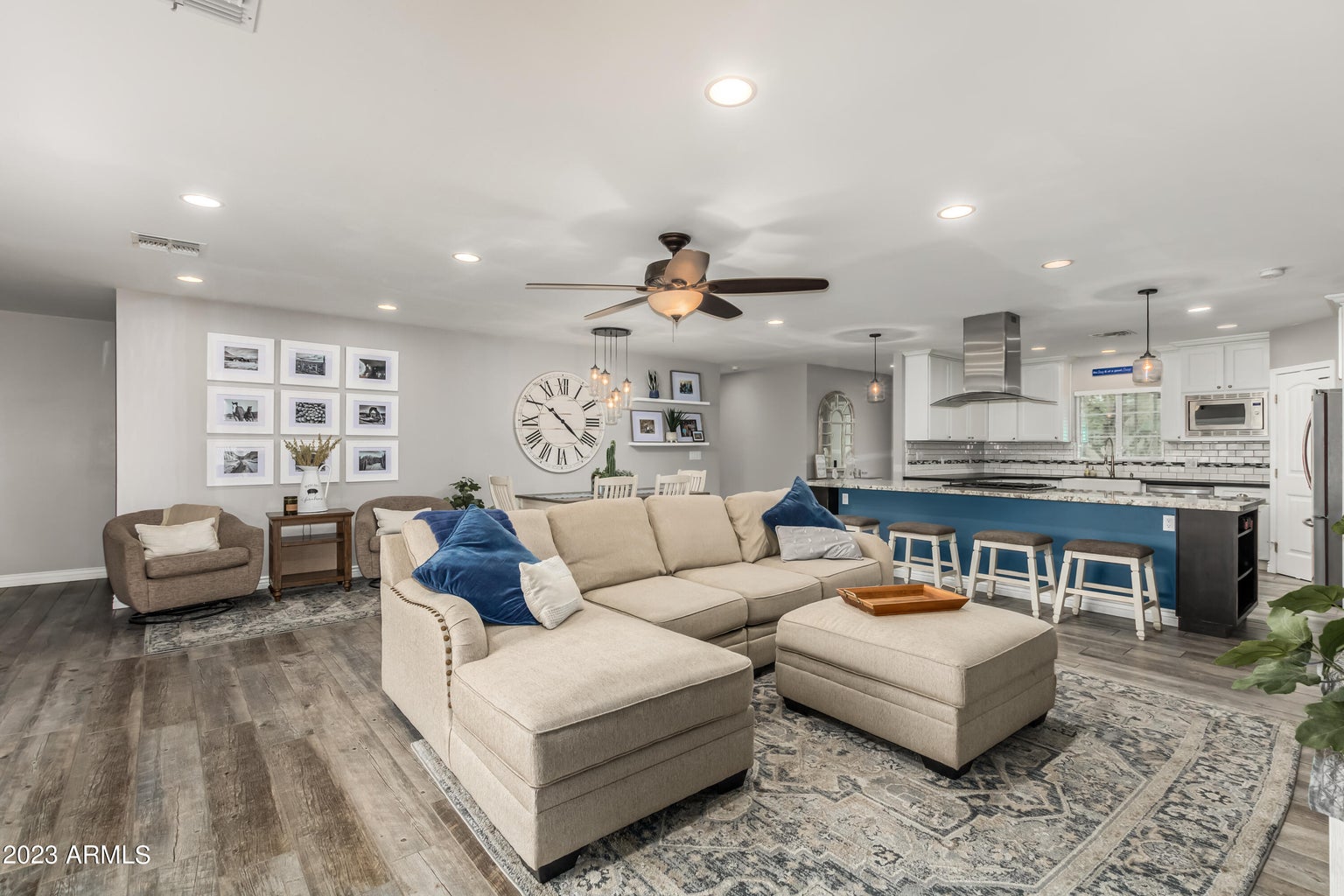 A luxury real estate living room in Greater Scottsdale, featuring hardwood floors and a ceiling fan.