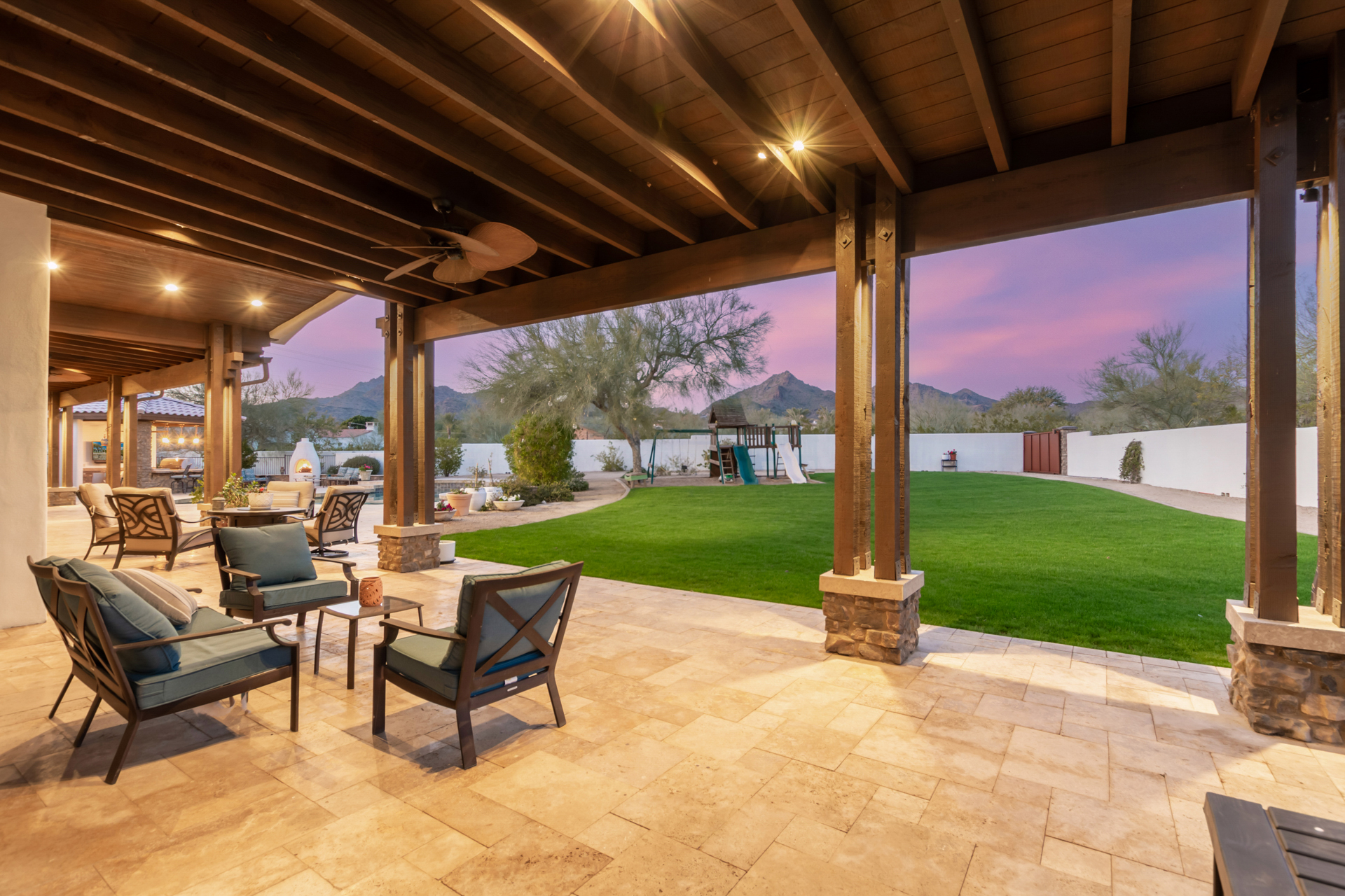 A luxury patio with a fire pit and outdoor furniture by Denali Development Construction in Greater Scottsdale.